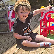 Remmington is registered to the contest to win money with this photo: barn_toy, black_tshirt, boy, casual_clothing, child, daylight, furniture, happy, hat, outdoor, person, play, smiling, sock, spiderman_sock, summer, sunlight, toy, toy_car, wooden_deck