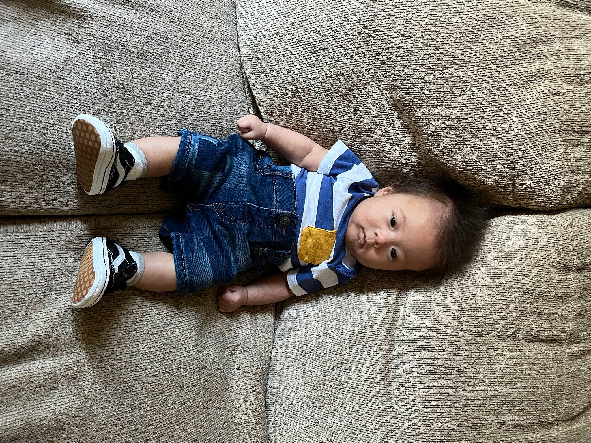 Kashton is registered to the contest to win money with this photo: baby, child, comfort, couch, denim, fashion_accessory, flooring, foot, glasses, grass, joint, leg, mammal, pattern, person, sitting, skin, textile, toddler, tree