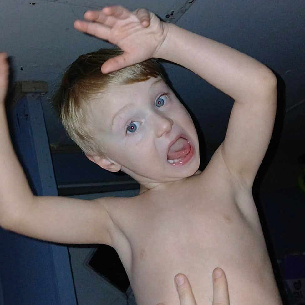 Wesley is registered to the contest to win money with this photo: animal, baby, bird, bodypart, clothing, door, face, finger, hand, happy, head, indoors, laughing, mouth, pants, person, photography, portrait, t_shirt, teeth