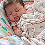 Kira is registered to the contest to win money with this photo: baby, sleeping, blanket, floral, cushion, baby_seat, animal_print, peaceful, infant, child, soft_lighting, cute, cozy, indoors, resting, portrait, closeup, comfort, toddler, nursery