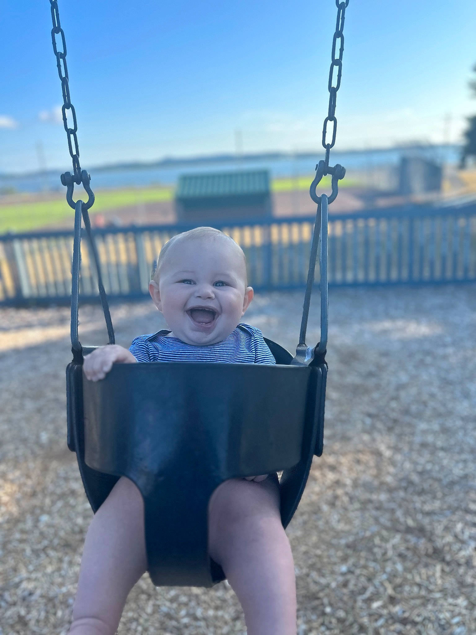 Axell is registered to the contest to win money with this photo: azure, baby, baby_toddler_clothing, beauty, black, city, electric_blue, eye, grass, happy, head, human_body, leisure, people_in_nature, person, playground, sky, smile, swing, toddler