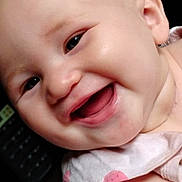 Grace is registered to the contest to win money with this photo: baby, smiling, face, close_up, infant, child, happy, skin, eye, mouth, cheek, ear, clothing, fabric, light, portrait, cute, expression, person, young