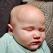 Grace is registered to the contest to win money with this photo: baby, infant, sleeping, onesie, cheek, ear, face, couch, sofa, pillow, blanket, skin, peaceful, closeup, portrait, home, nap, toddler_like, soft_light, relaxation