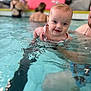 Amelia joined the competition — help win amazing prizes! baby, child, swimming_pool, water, adult, fun, splash, smile, person, indoor, recreation, support, swimwear, blue, happy, playing, leisure, family, poolside, people