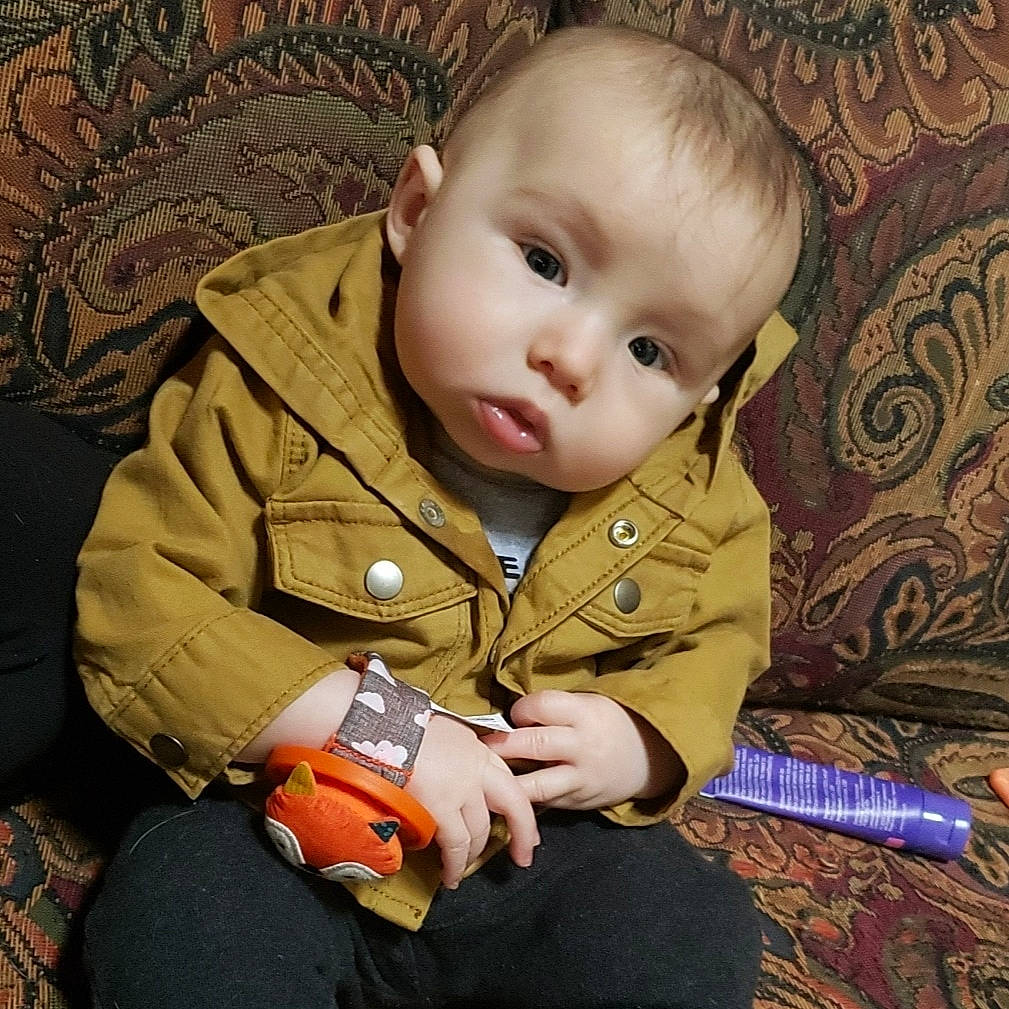 Jessie joined the competition — help win amazing prizes! baby, baby_toddler_clothing, brown, cheek, child, collar, comfort, eye, head, iris, mammal, nose, organ, outerwear, person, sitting, skin, sleeve, textile, toddler