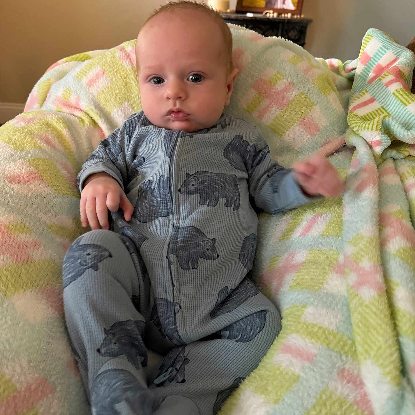 Brantley is registered to the contest to win money with this photo: art, baby, bed, bedroom, blanket, bodypart, couch, cushion, face, furniture, head, homedecor, indoors, painting, person, photography, portrait, quilt, room, sitting