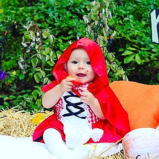 Kora is registered to the contest to win money with this photo: baby, child, child_model, clothing, costume, fashion_accessory, headgear, leisure, lip, outerwear, person, photo_shoot, photography, pink, play, red, toddler