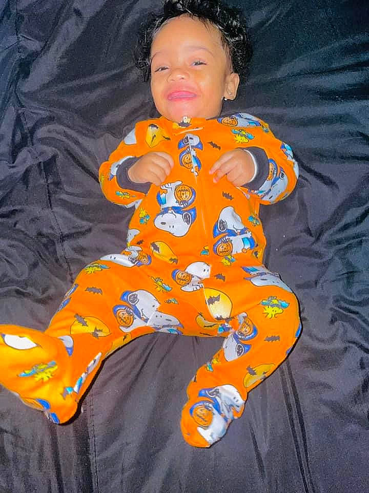 Damari joined the competition — help win amazing prizes! baby, baby_products, baby_toddler_clothing, child, comfort, electric_blue, eye, face, fun, happy, head, linens, orange, pattern, person, sitting, sleeve, smile, t_shirt, textile