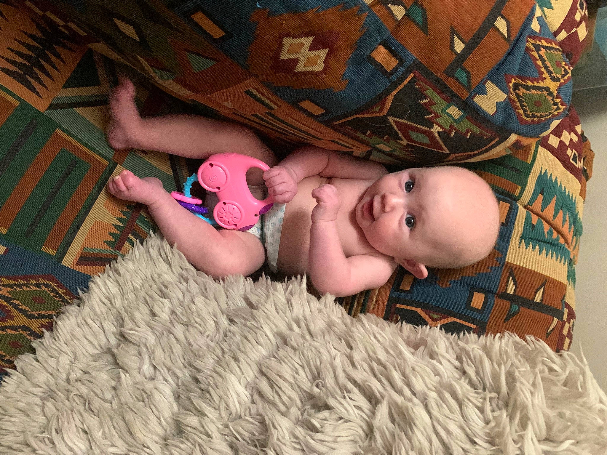 Averi is registered to the contest to win money with this photo: baby, baby_toddler_clothing, cheek, child, comfort, eye, flooring, fun, grass, happy, headgear, linens, mammal, pattern, person, pink, room, skin, textile, toddler