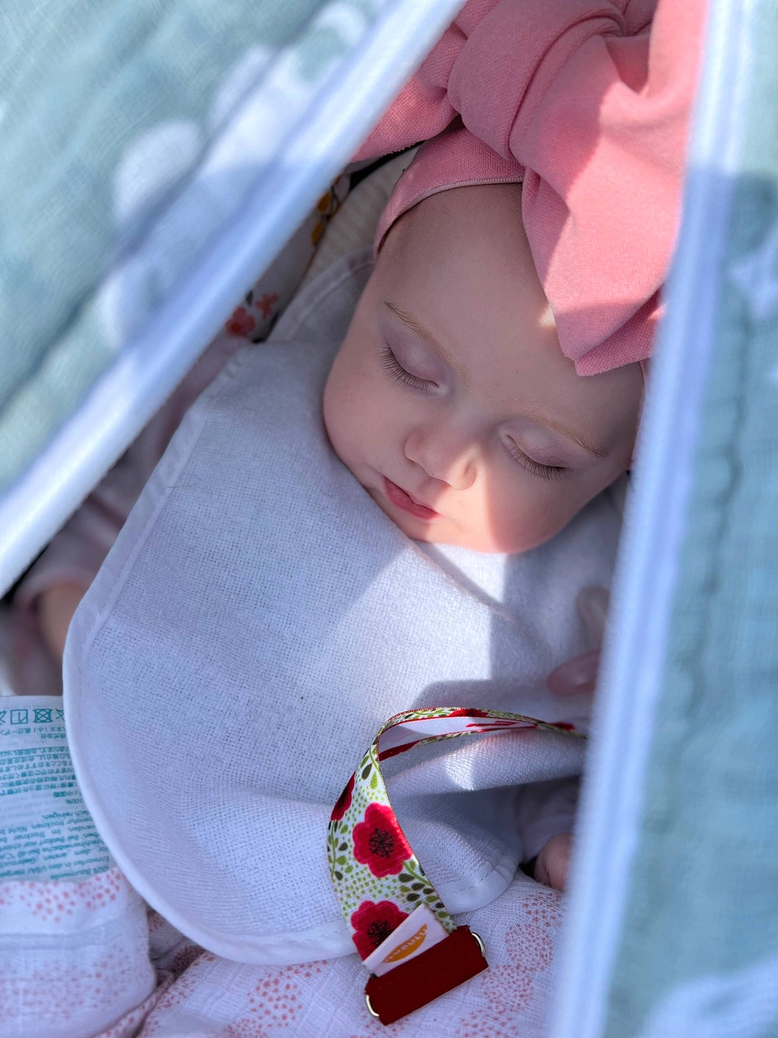 Melodie is registered to the contest to win money with this photo: baby, baby_products, car_seat, carmine, child, chin, comfort, eyelash, face, fashion_accessory, happy, headwear, linens, lip, pattern, person, skin, toddler, window
