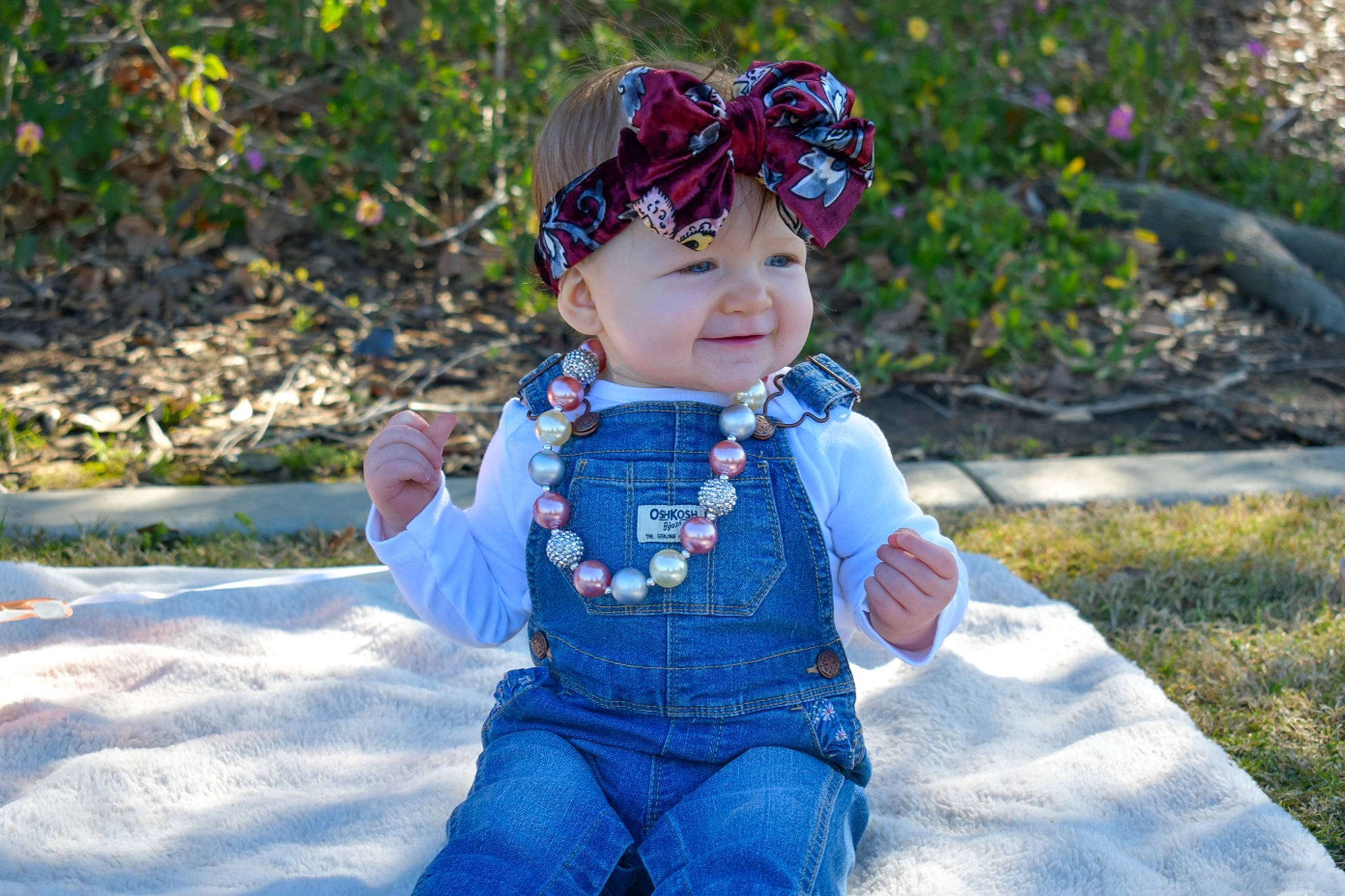 Andie is registered to the contest to win money with this photo: baby, baby_toddler_clothing, cap, child, clothing, electric_blue, eye, fun, grass, happy, head, headband, headwear, joy, leisure, people, people_in_nature, person, personal_protective_equipment, plant