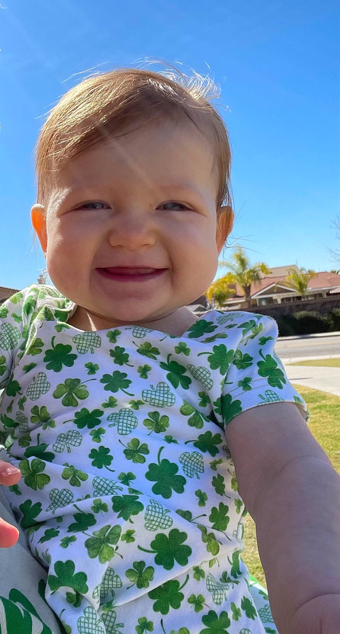 Andie is registered to the contest to win money with this photo: baby_toddler_clothing, cheek, chin, dress, eye, facial_expression, grass, happy, iris, joy, leaf, lip, neck, nose, person, plant, skin, sky, sleeve, smile