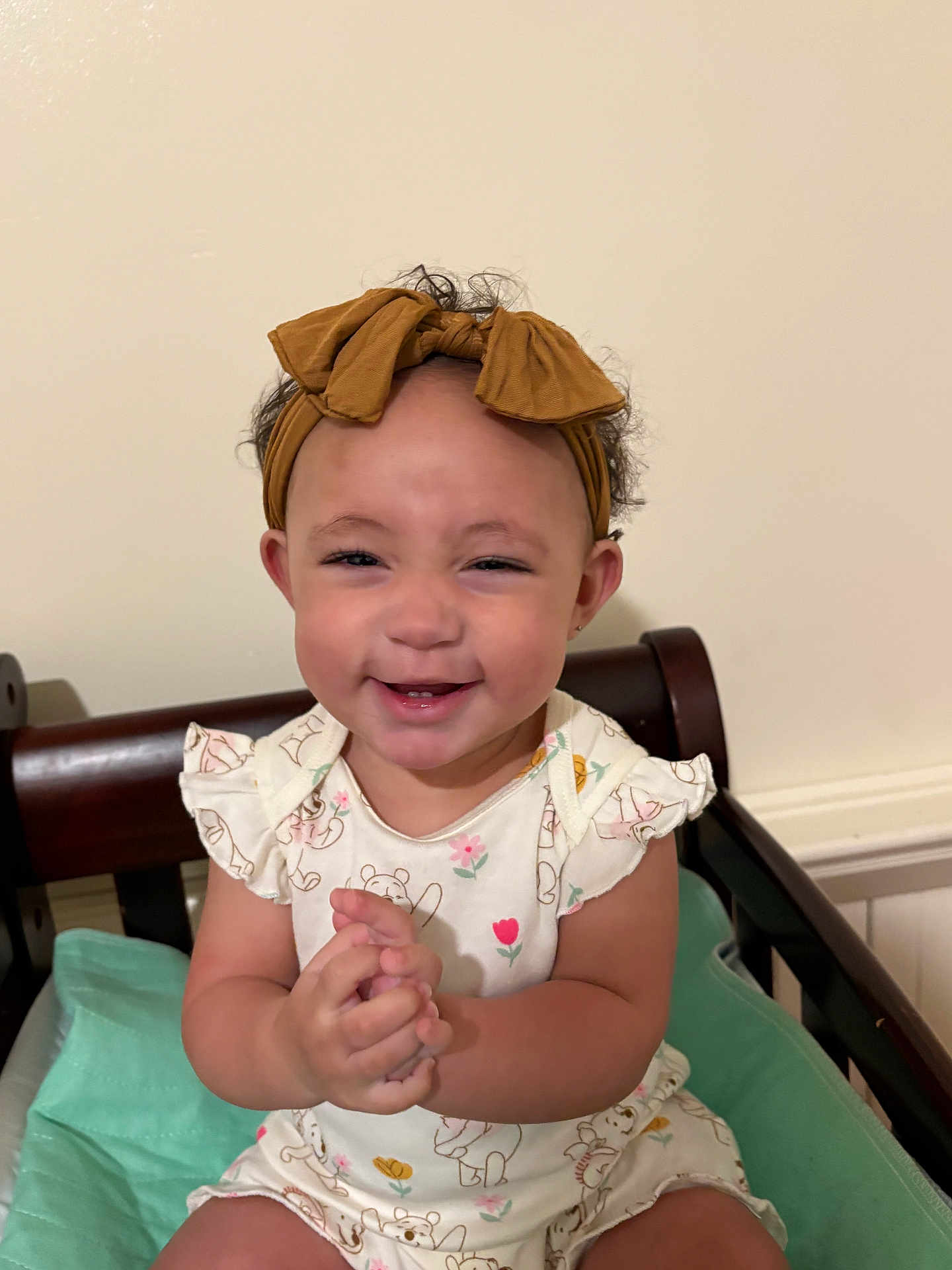 Aubriella joined the competition — help win amazing prizes! toddler, child, smiling, headband, bow, clothing, sitting, happy, baby, face, hands, indoor, furniture, chair, cute, portrait, infant, person, apparel, skin