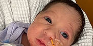 Aubriella is registered to the contest to win money with this photo: newborn, baby, infant, blanket, medical_tube, hospital, face, hand, person, wrapped, closeup, comfort, healthcare, cute, eyes, skin, indoors, wearing, soft, pink_stars