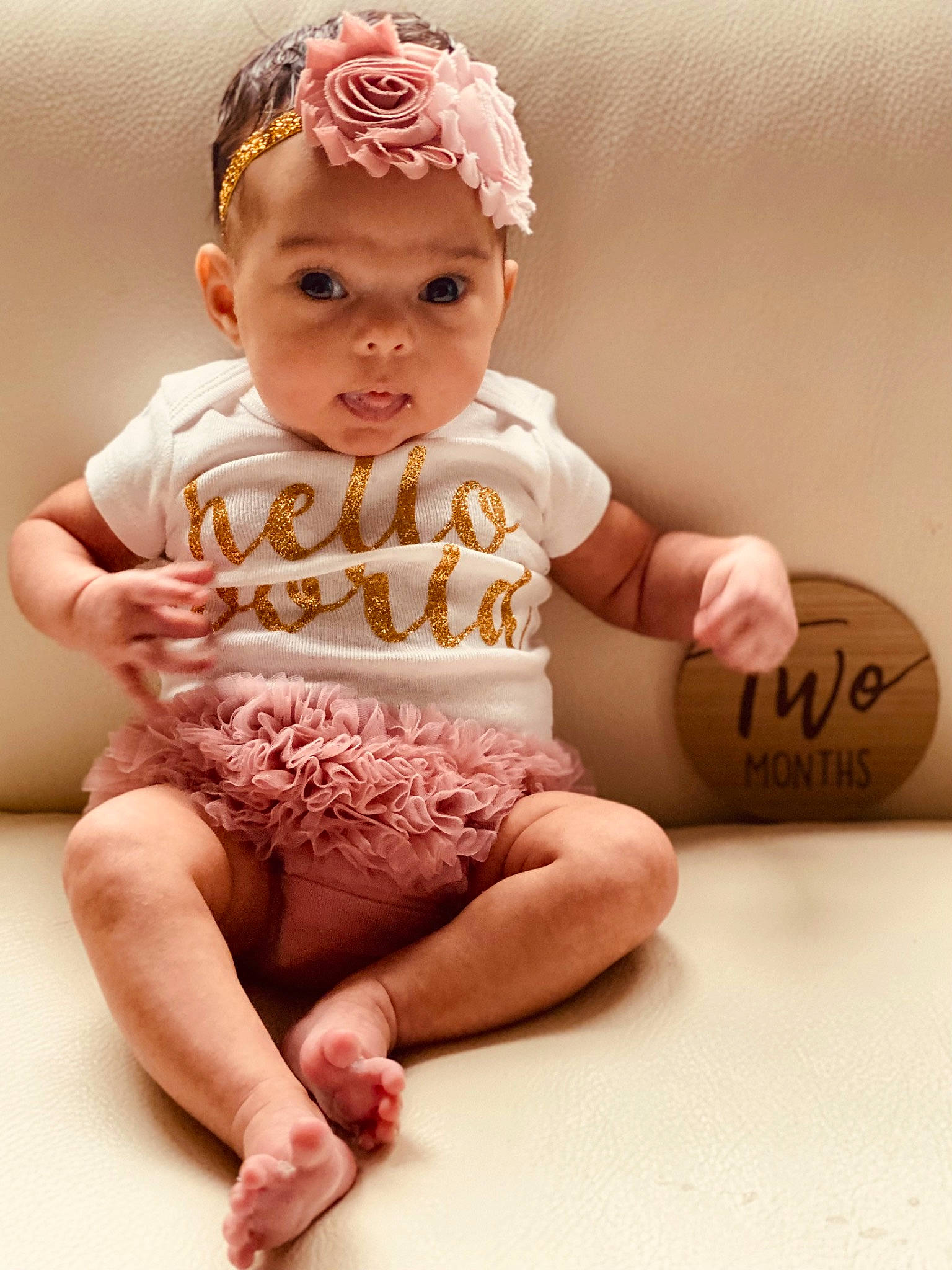 Gia is registered to the contest to win money with this photo: baby, baby_toddler_clothing, barefoot, cheek, child, fashion_accessory, finger, foot, headwear, human_leg, knee, leg, nail, peach, person, pink, sitting, skin, sleeve, thigh
