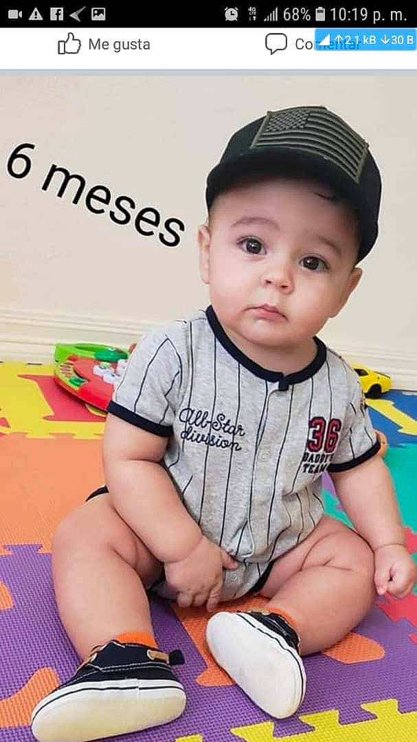 Alejandro Alfonso is registered to the contest to win money with this photo: baby, baby_toddler_clothing, baseball_cap, cap, child, cool, flooring, fun, happy, human_leg, knee, leisure, pattern, person, shirt, sitting, skin, sleeve, t_shirt, thigh