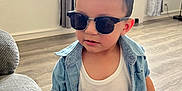 Jaden joined the competition — help win amazing prizes! child, toddler, sunglasses, denim_shirt, white_tank_top, indoor, living_room, floor, curtains, window, bracelet, shorts, person, furniture, casual, cool, young, cute, home, style