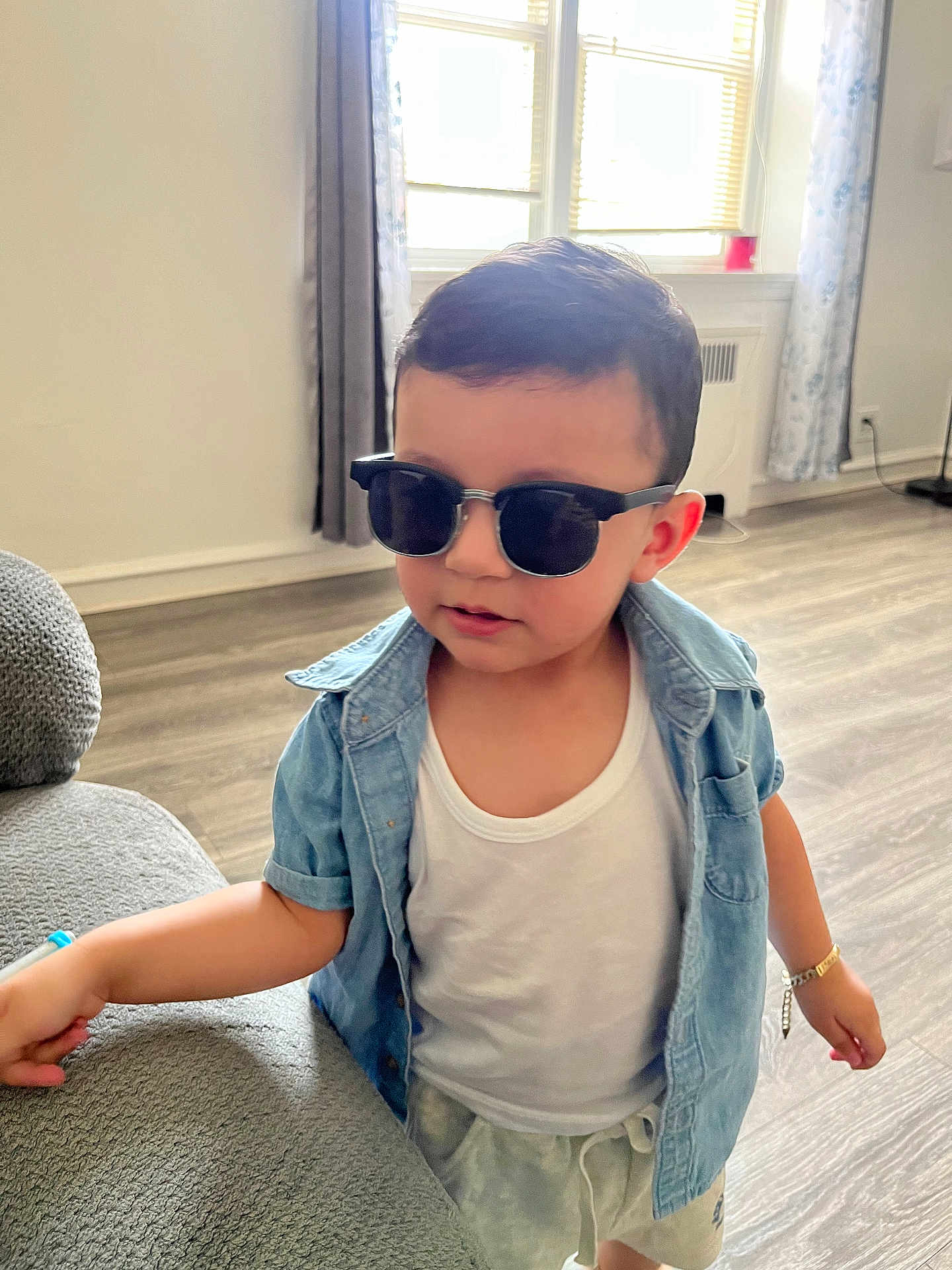 Jaden joined the competition — help win amazing prizes! child, toddler, sunglasses, denim_shirt, white_tank_top, indoor, living_room, floor, curtains, window, bracelet, shorts, person, furniture, casual, cool, young, cute, home, style