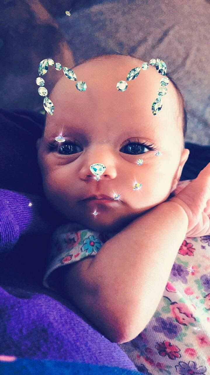 Honesti is registered to the contest to win money with this photo: beauty, cheek, child, close_up, eye, eyebrow, eyelash, face, forehead, girl, hair_accessory, head, headpiece, infant, jewellery, lip, mouth, person, purple, skin