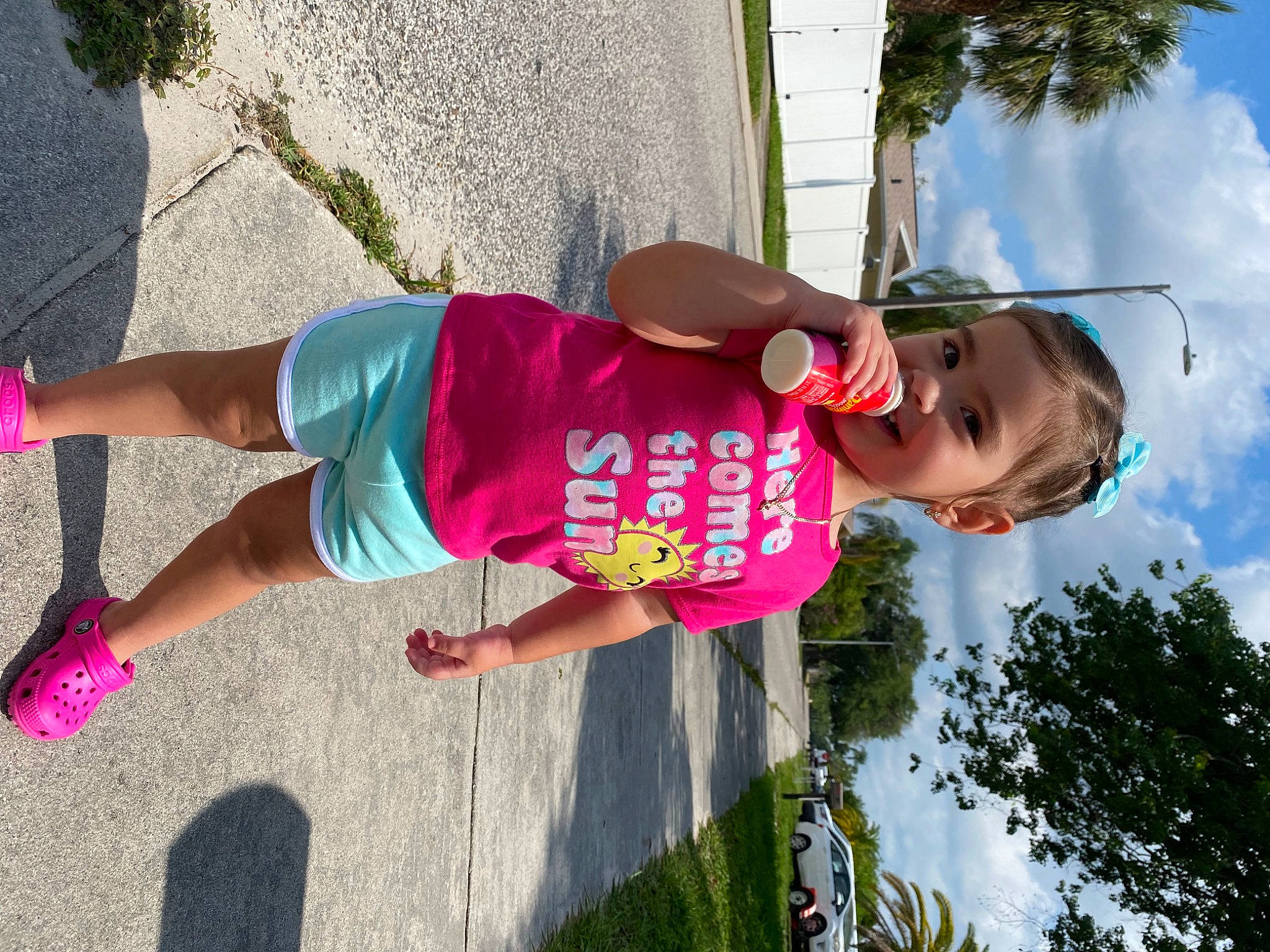 Sophia is registered to the contest to win money with this photo: cloud, eyewear, fun, happy, hat, human_leg, joy, knee, leisure, magenta, person, pink, plant, recreation, shorts, sky, sunglasses, t_shirt, thigh, tree