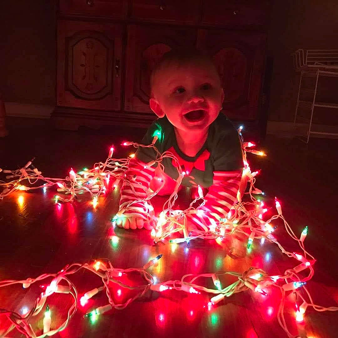 Ashton joined the competition — help win amazing prizes! christmas_decoration, darkness, diwali, electric_blue, electricity, entertainment, event, fireworks, fun, holiday, magenta, midnight, neon, new_year, night, party_supply, person, recreation, smile, space