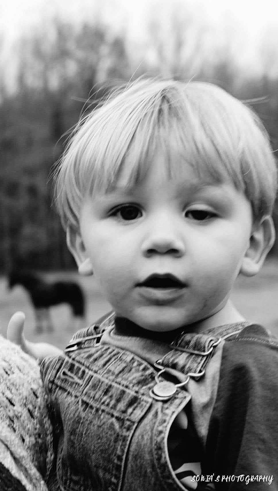 Ashton is registered to the contest to win money with this photo: black, black_and_white, cheek, child, face, facial_expression, flash_photography, happy, human, human_body, iris, nose, organ, person, photograph, skin, smile, standing, style, toddler