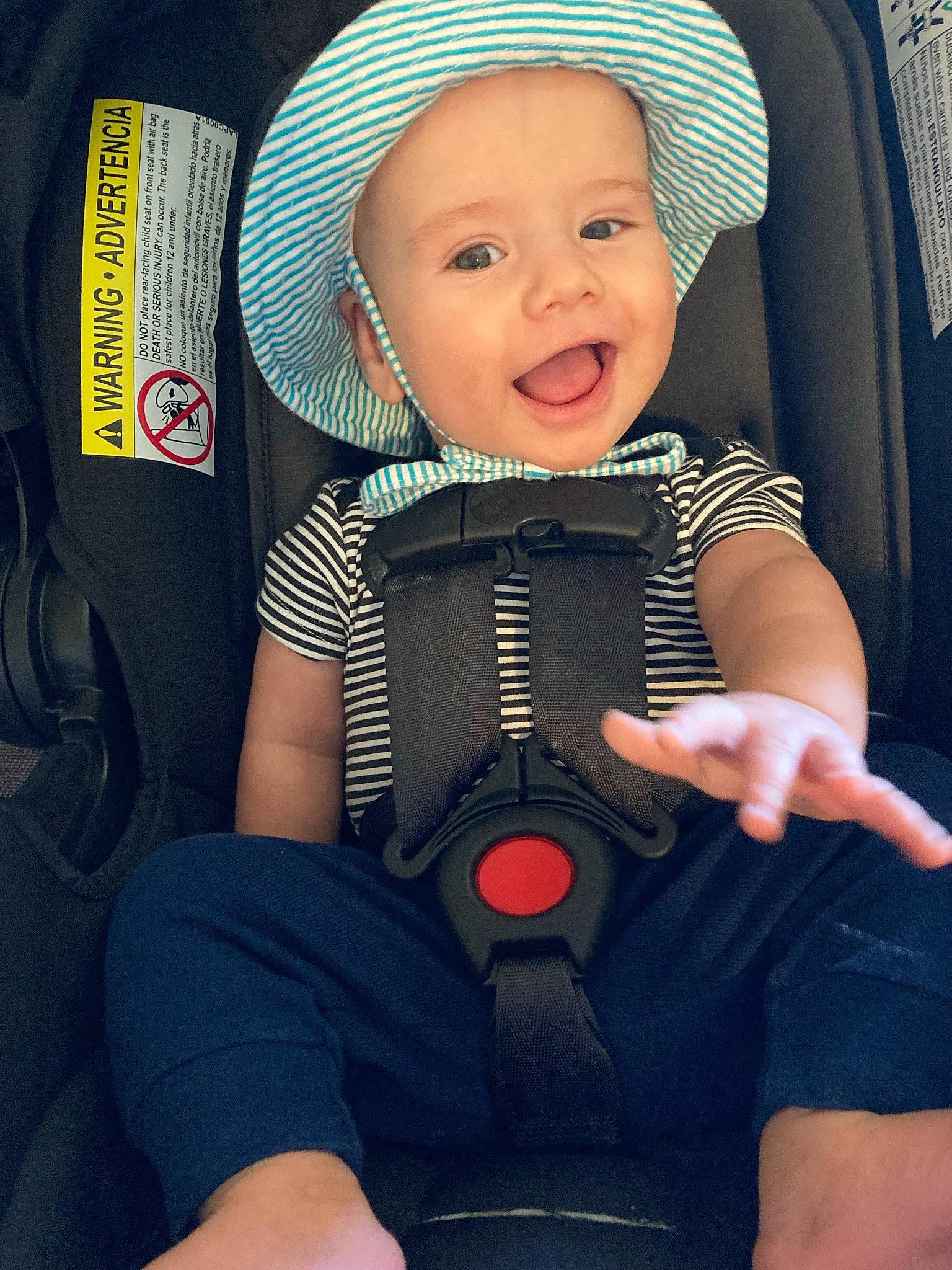 Cayde is registered to the contest to win money with this photo: baby, baby_in_car_seat, baby_toddler_clothing, blue, child, comfort, cool, facial_expression, finger, fun, hand, happy, headgear, headwear, organ, person, personal_protective_equipment, product, skin, smile