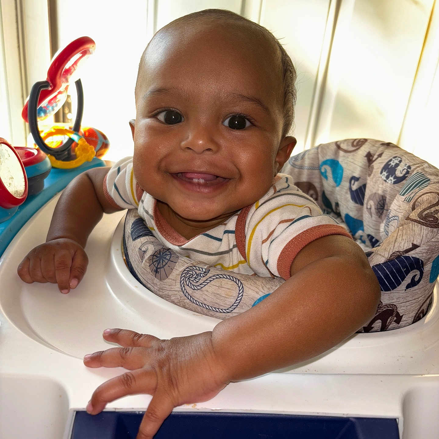 Naheem is registered to the contest to win money with this photo: baby, bodypart, clothing, cutlery, face, finger, furniture, hand, happy, head, indoors, mouth, person, photography, portrait, sitting, smile, spoon, t_shirt, tape