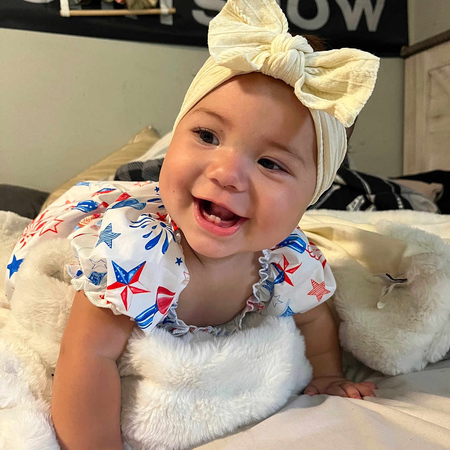 Iliana joined the competition — help win amazing prizes! baby, bed, blanket, bow, child, clothing, cute, fabric, face, hand, happy, headband, indoors, infant, person, portrait, room, skin, smiling, star_pattern