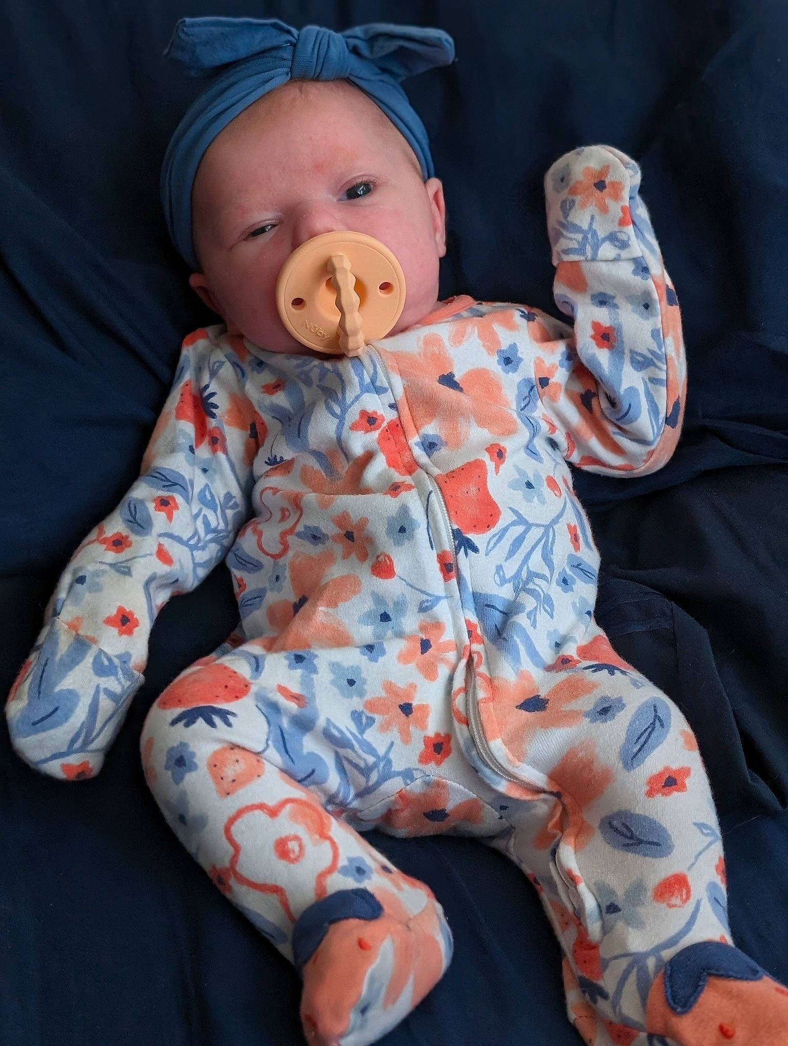 Mallory is registered to the contest to win money with this photo: baby, baby_products, baby_sleeping, baby_toddler_clothing, baby_toys, cap, carmine, child, comfort, doll, linens, orange, pattern, person, personal_protective_equipment, sitting, sleeve, stuffed_toy, textile, toddler