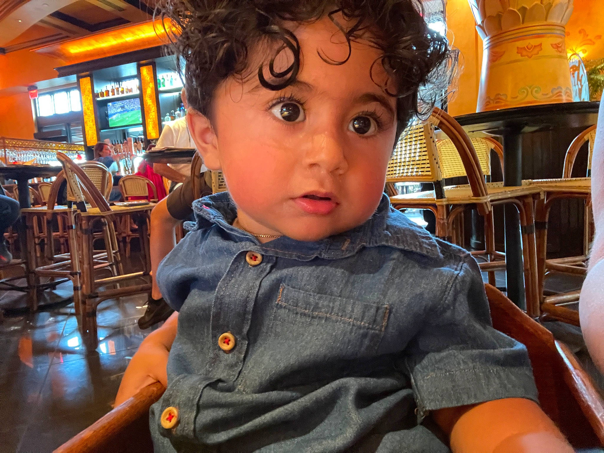 Nikolai is registered to the contest to win money with this photo: chair, cheek, child, chin, ear, fun, happy, human, leisure, nose, person, sitting, skin, sleeve, snapshot, t_shirt, table, television, toddler, travel