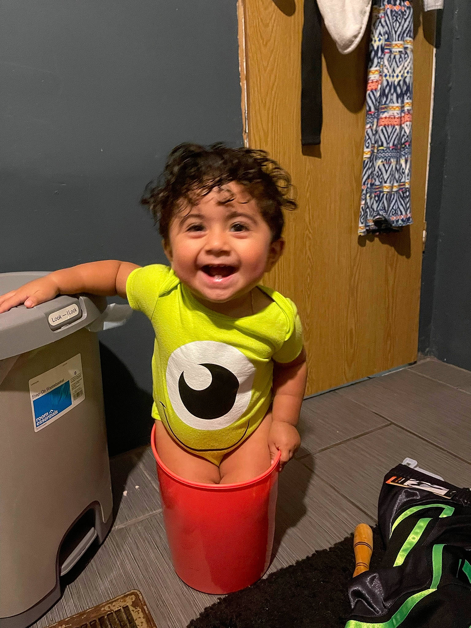 Nikolai is registered to the contest to win money with this photo: baby, bucket, child, curtain, door, flooring, fun, green, happy, leisure, office_supplies, person, play, recycling_bin, room, smile, standing, t_shirt, toddler, vacation