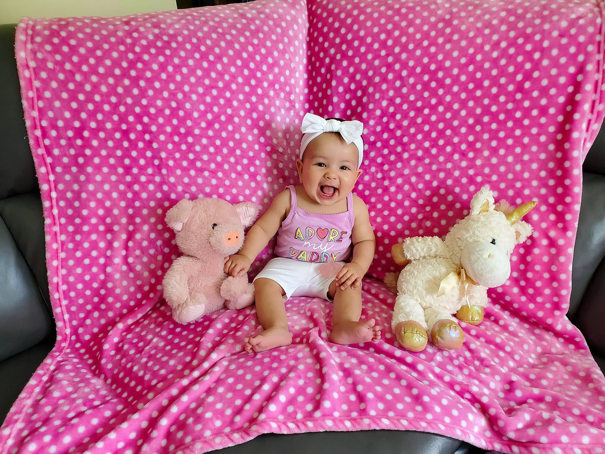 Elora is registered to the contest to win money with this photo: baby_toddler_clothing, bed, bedding, comfort, couch, doll, fawn, furniture, linens, magenta, pattern, person, pillow, pink, plush, sock, stuffed_toy, teddy_bear, textile, throw_pillow