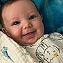 Maddie joined the competition — help win amazing prizes! baby, smile, face, blanket, cozy, infant, cute, happy, clothing, pattern, child, portrait, indoors, warm, cute_expression, young, person, soft, wrapped, pacifier