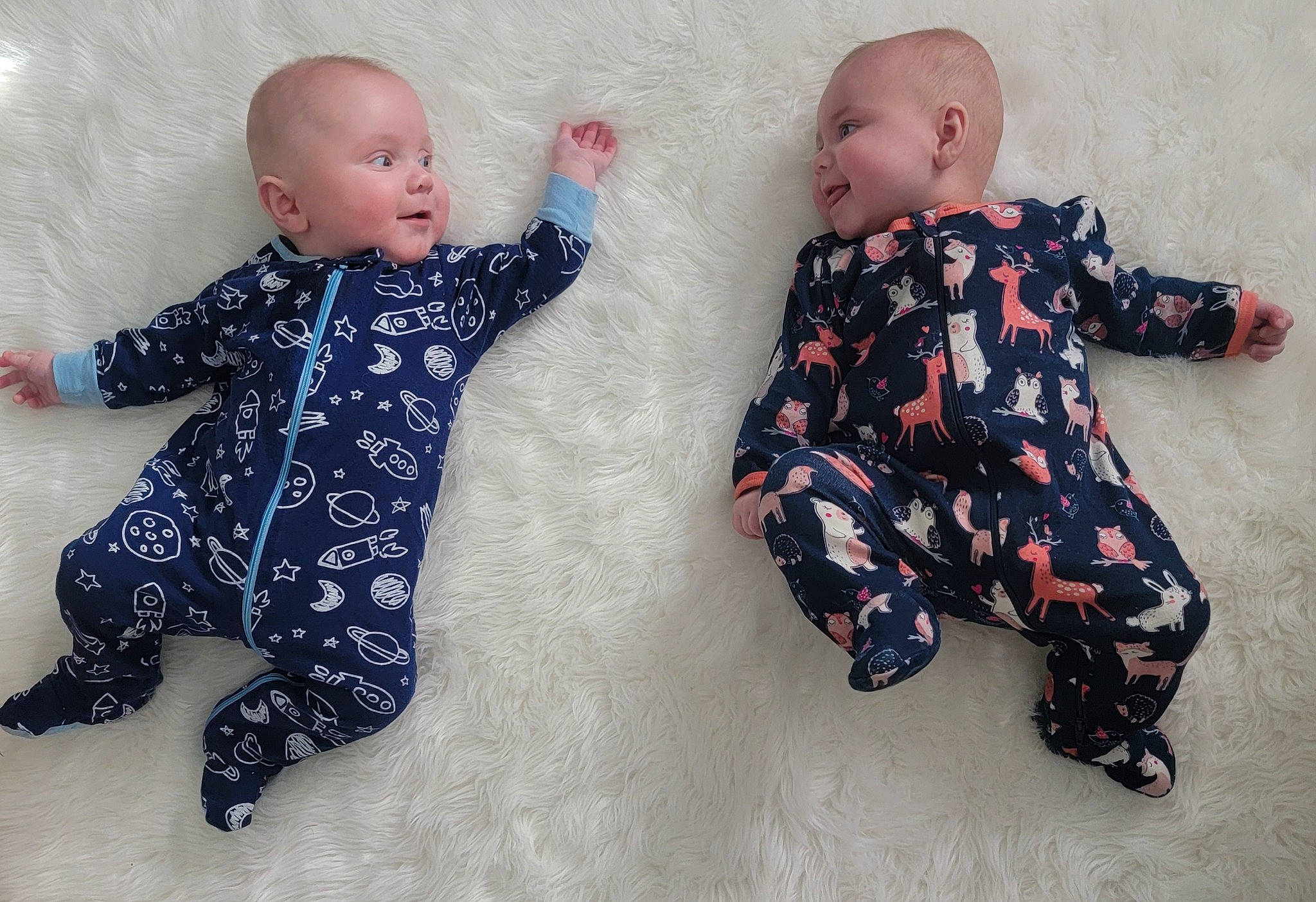 Emmalyn is registered to the contest to win money with this photo: arm, baby, baby_toddler_clothing, cheek, comfort, finger, flooring, foot, gesture, hand, happy, human_body, joint, leg, outerwear, pattern, person, sitting, skin, sleeve