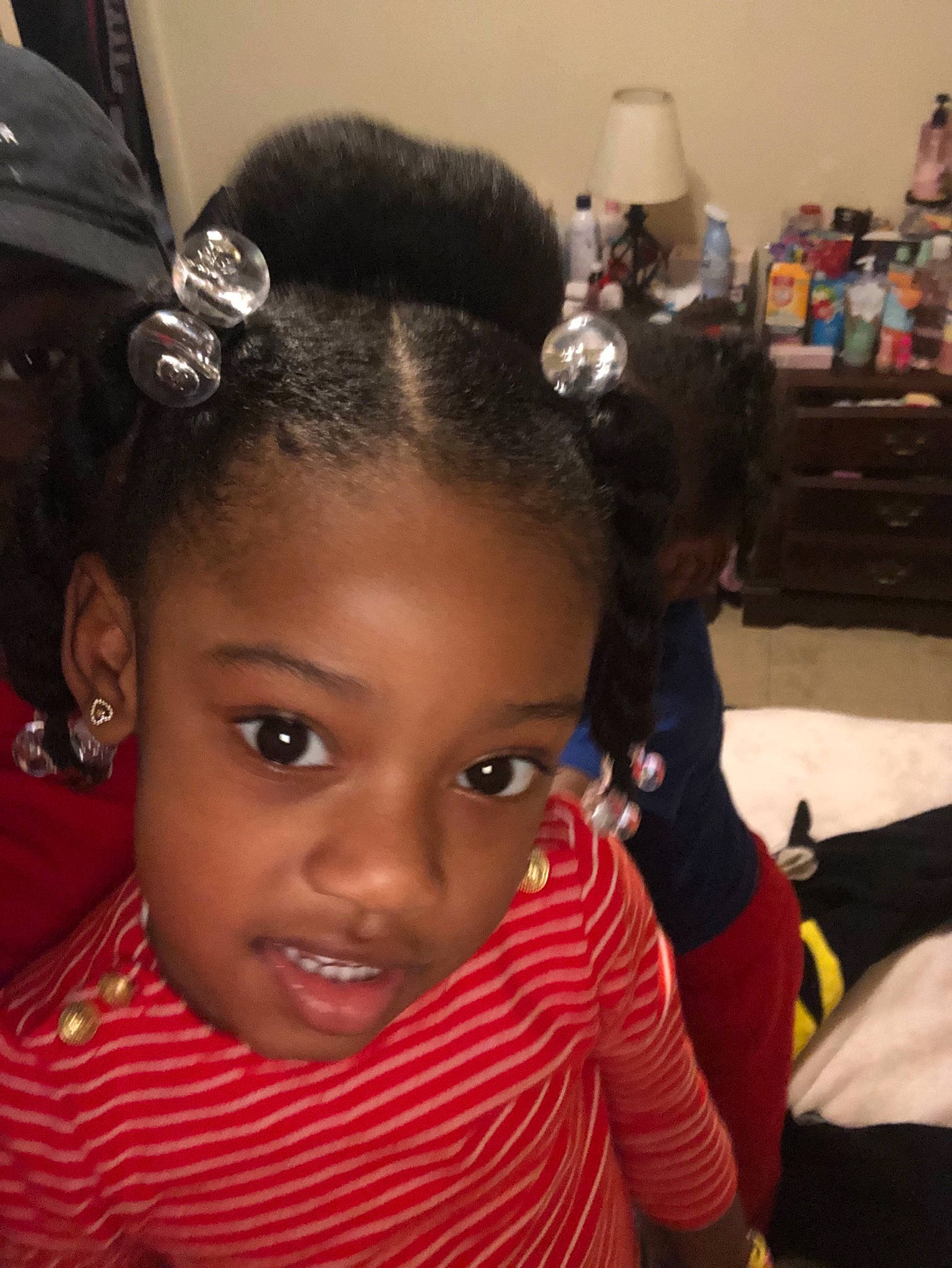 Germany is registered to the contest to win money with this photo: black_hair, cheek, child, ear, eyebrow, face, fashion_accessory, forehead, hair, hair_accessory, hairstyle, head, long_hair, person, skin, smile