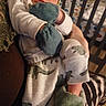 newborn, baby, sleeping, infant, crib, dinosaur, outfit, mittens, teal, clothing, blanket, nursery, portrait, peaceful, cozy, indoors, cuddly, resting, face, photography