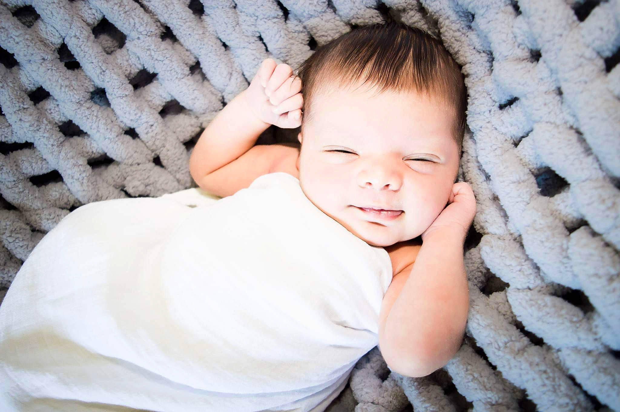Xavion is registered to the contest to win money with this photo: baby, baby_toddler_clothing, child, comfort, facial_expression, flash_photography, grass, happy, iris, linens, mammal, pattern, person, portrait_photography, sitting, skin, sleeve, smile, textile, toddler