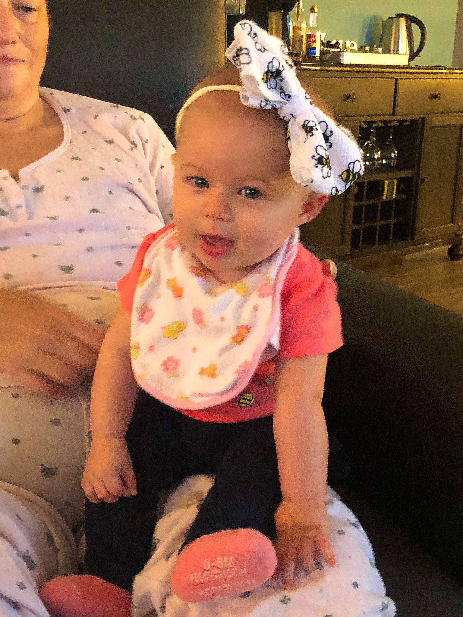 Margaret is registered to the contest to win money with this photo: baby, baby_toddler_clothing, cheek, child, event, face, facial_expression, fun, happy, head, headpiece, pattern, person, pink, sitting, skin, sleeve, smile, t_shirt, toddler