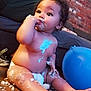 Devi is registered to the contest to win money with this photo: baby, balloon, bodypart, clothing, couch, cream, dessert, face, finger, food, footwear, furniture, hand, hardwood, head, icing, person, shoe, sphere, wood