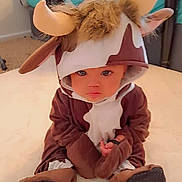 Devi joined the competition — help win amazing prizes! baby, cartoon, clothing, costume, couch, doll, elf, face, furniture, hat, head, hosiery, kneeling, person, photography, plush, portrait, sitting, sock, toy