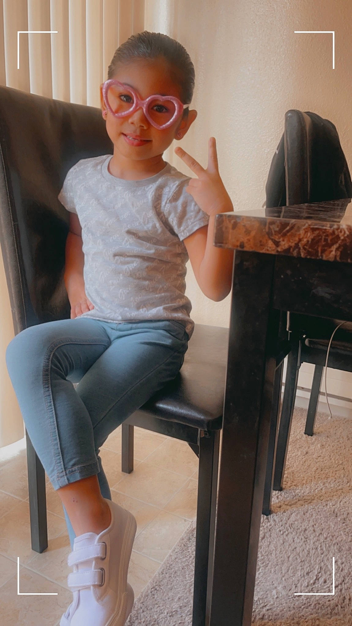 Lily is registered to the contest to win money with this photo: black, comfort, eyewear, glasses, human_body, human_leg, joint, joy, knee, leg, neck, person, shorts, shoulder, sleeve, sunglasses, t_shirt, table, textile, thigh