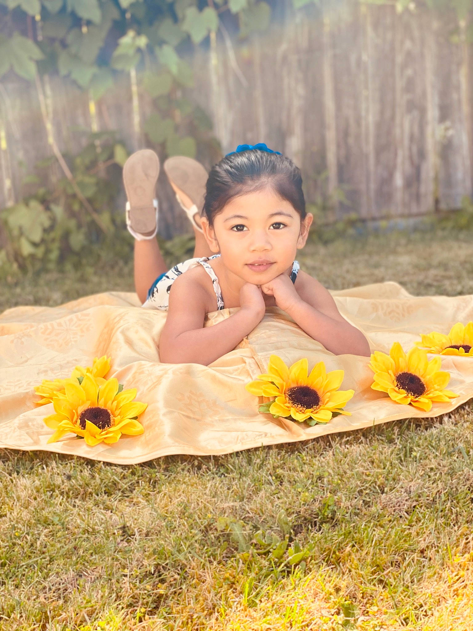 Lilyrose is registered to the contest to win money with this photo: adaptation, child, dress, facial_expression, flash_photography, flower, fun, grass, happy, headpiece, jewellery, landscape, leisure, people_in_nature, person, petal, plant, sitting, sunlight, vertebrate