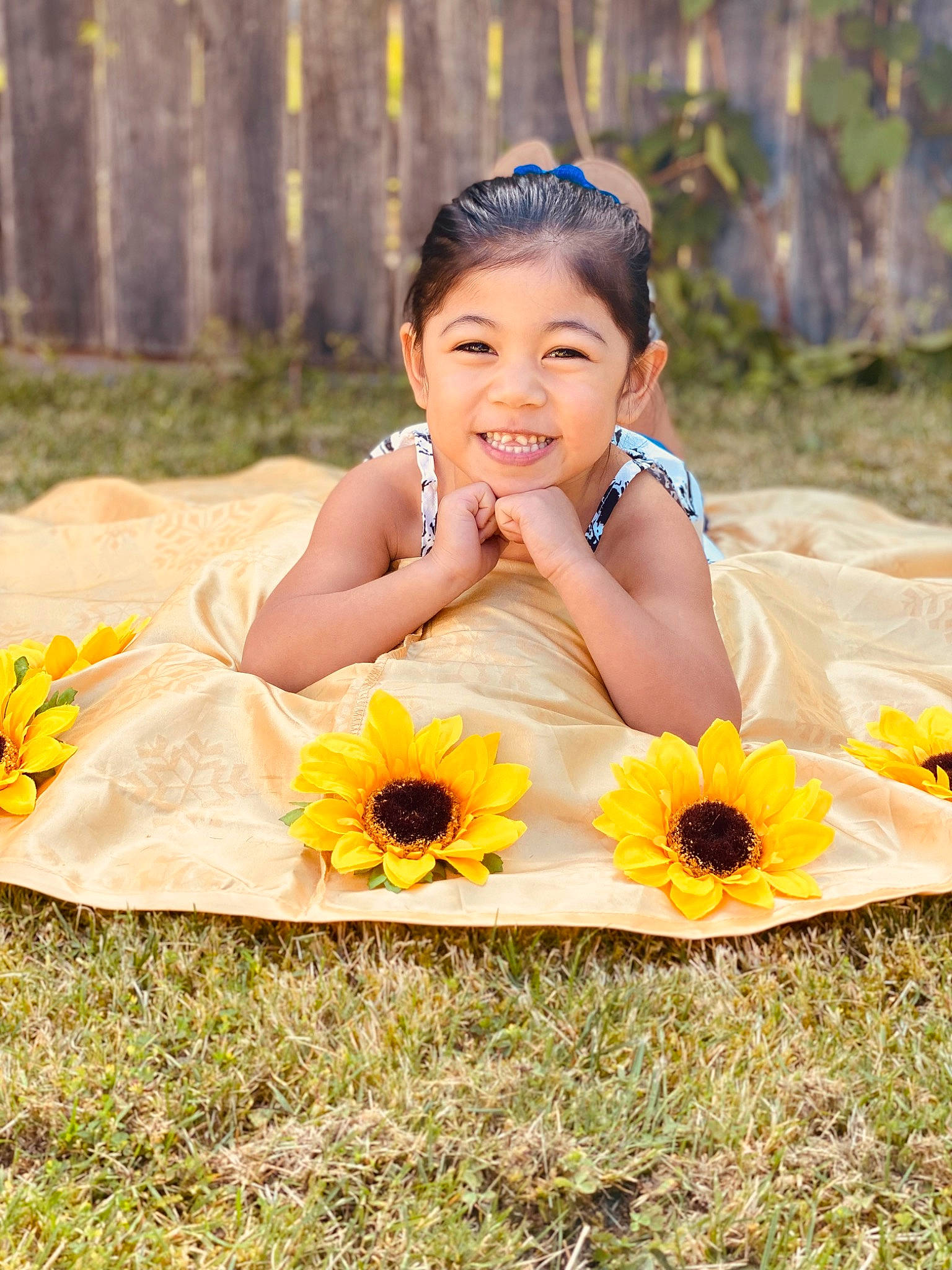 Lilyrose is registered to the contest to win money with this photo: arm, dress, eye, face, flower, flowering_plant, fun, grass, happy, headpiece, joy, landscape, leisure, nature, people_in_nature, person, petal, plant, skin, sunflower