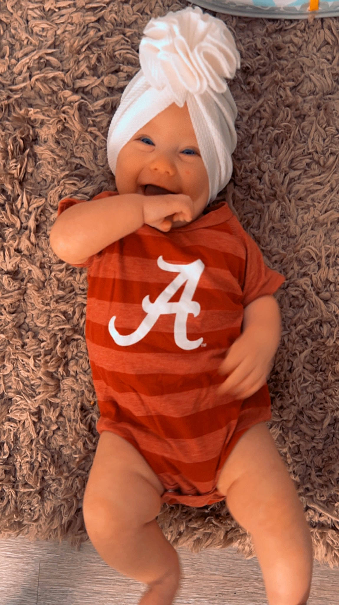 Annalise is registered to the contest to win money with this photo: arm, baby, baby_toddler_clothing, cap, clothing, face, facial_expression, finger, hand, head, headgear, headwear, outerwear, person, pink, shorts, skin, sleeve, smile, t_shirt