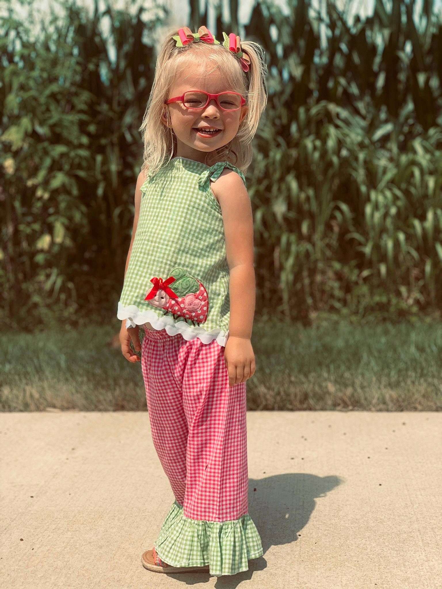 Vaydalynn is registered to the contest to win money with this photo: baby_toddler_clothing, day_dress, eyewear, goggles, grass, hair, happy, joy, magenta, one_piece_garment, people_in_nature, person, pink, plant, shoulder, skin, sleeve, street_fashion, sunglasses, textile