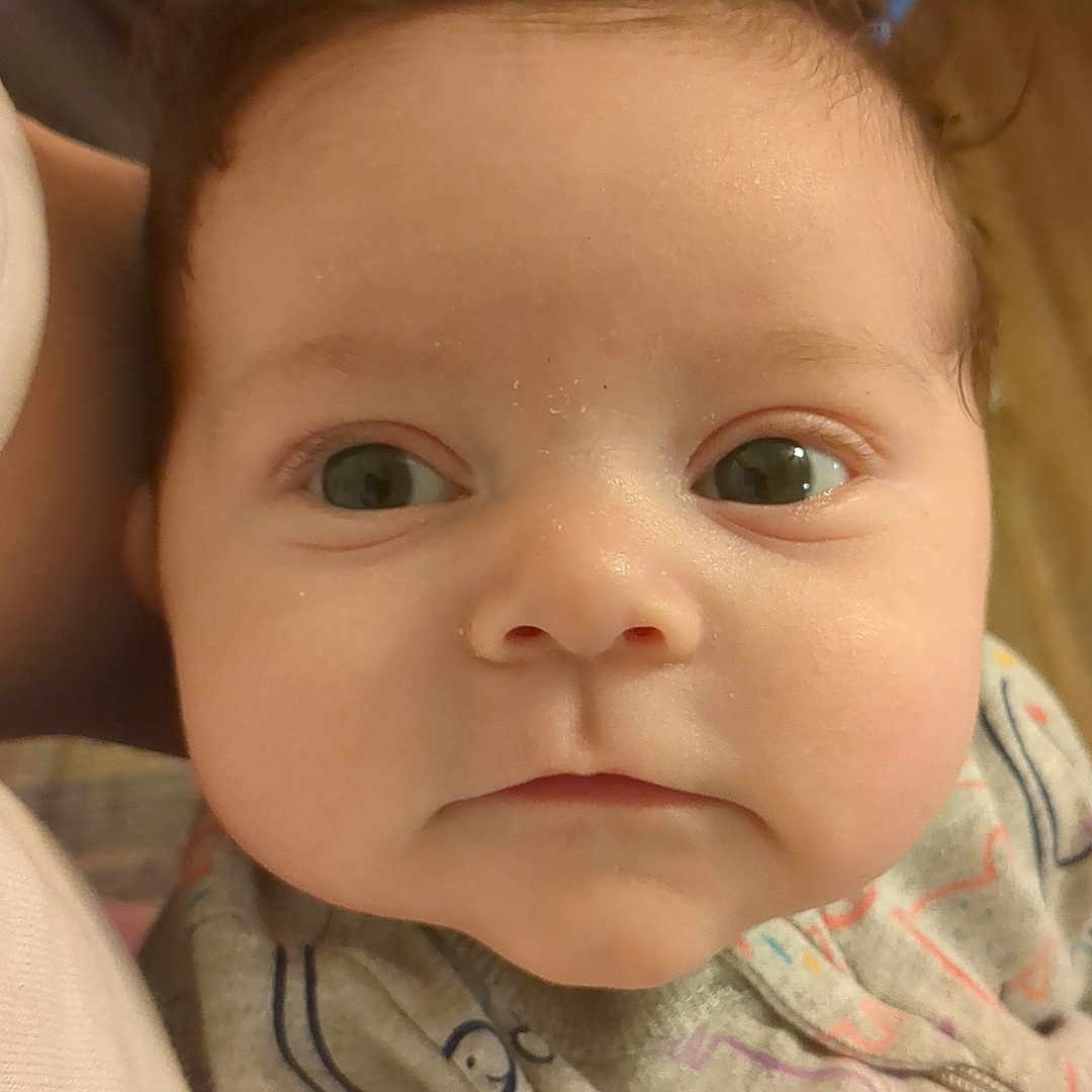 Ruby joined the competition — help win amazing prizes! baby, blanket, bodypart, clothing, couch, face, finger, furniture, hand, happy, head, knitwear, mouth, newborn, pants, person, photography, portrait, smile, sweater