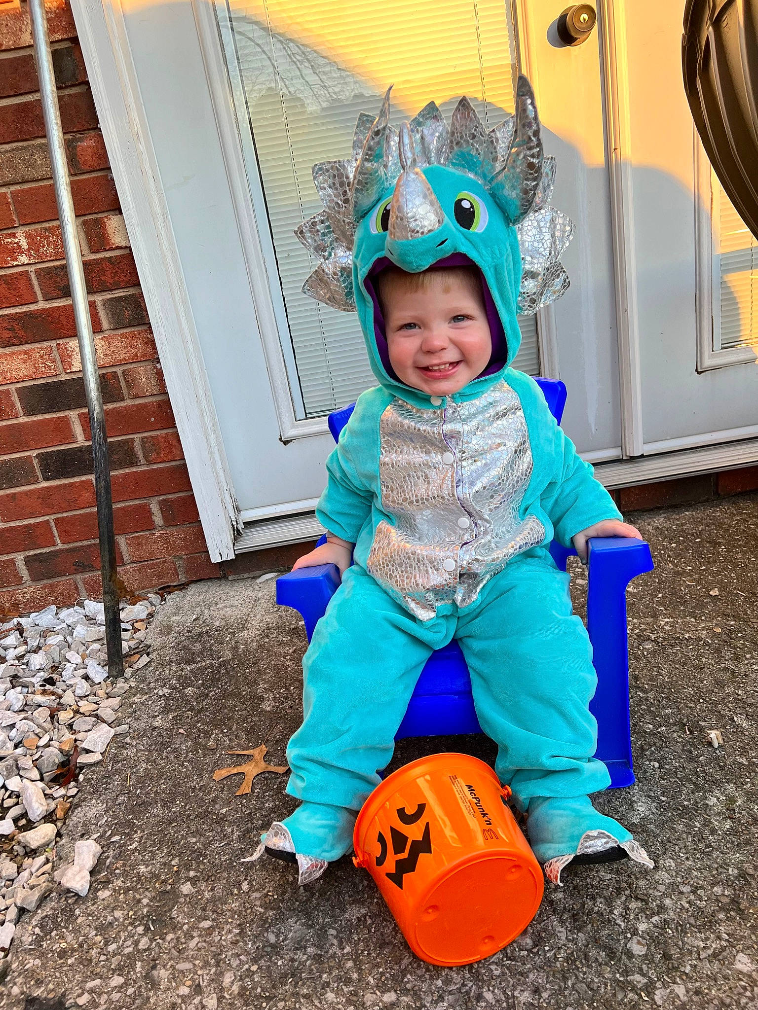 Axel is registered to the contest to win money with this photo: baby, baby_toddler_clothing, brick, brickwork, child, door, electric_blue, fun, grass, happy, headwear, joy, people_in_nature, person, personal_protective_equipment, play, recreation, sitting, smile, soil