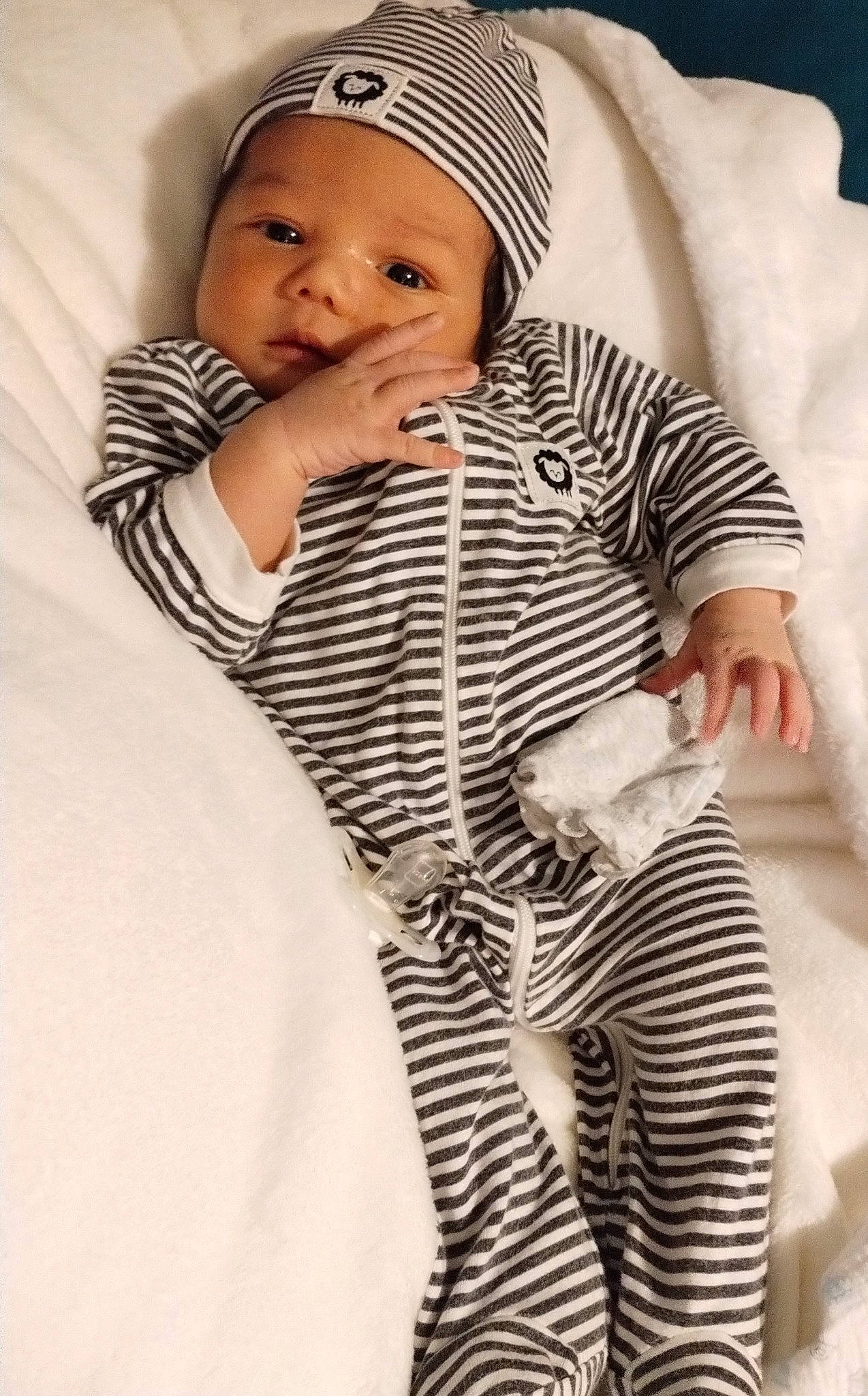 Ezequiel is registered to the contest to win money with this photo: baby, baby_sleeping, baby_toddler_clothing, cap, cheek, child, collar, comfort, eye, face, happy, head, headwear, knit_cap, lip, outerwear, pattern, person, skin, sleeve