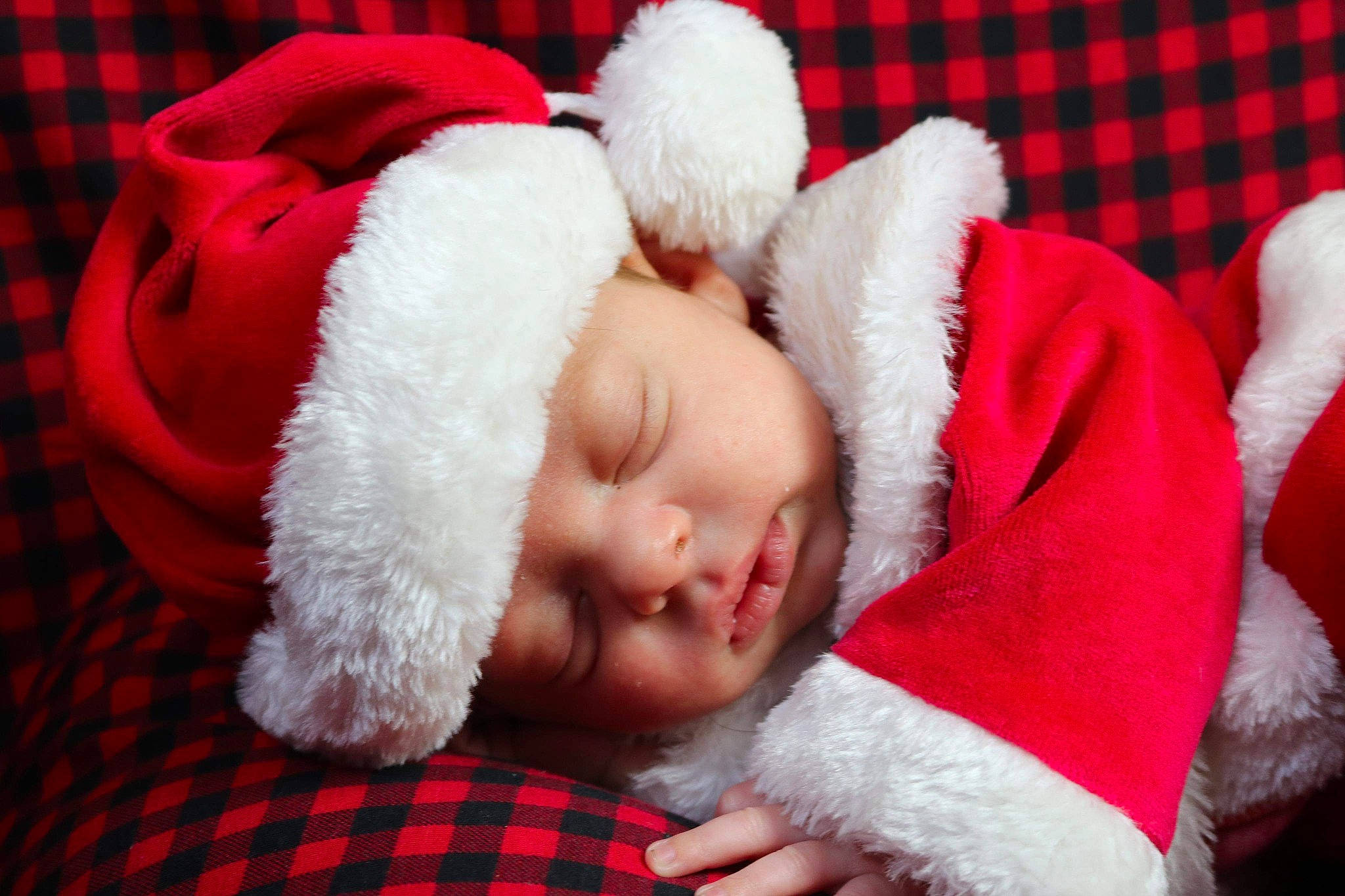 Jesiah joined the competition — help win amazing prizes! baby, baby_toddler_clothing, bedtime, carmine, child, christmas, christmas_eve, comfort, costume_accessory, fictional_character, fur, fur_clothing, headwear, linens, pattern, person, plaid, red, sleep, tartan
